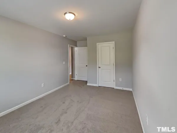 an empty room with closet area