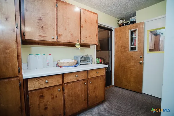 a bedroom with a bed and a flat tv screen on a dresser