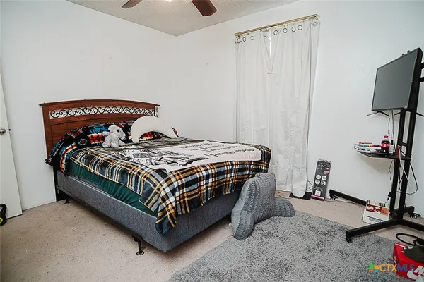 a bedroom with bed and window