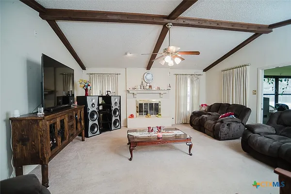 a view of a livingroom with furniture and a potted plant