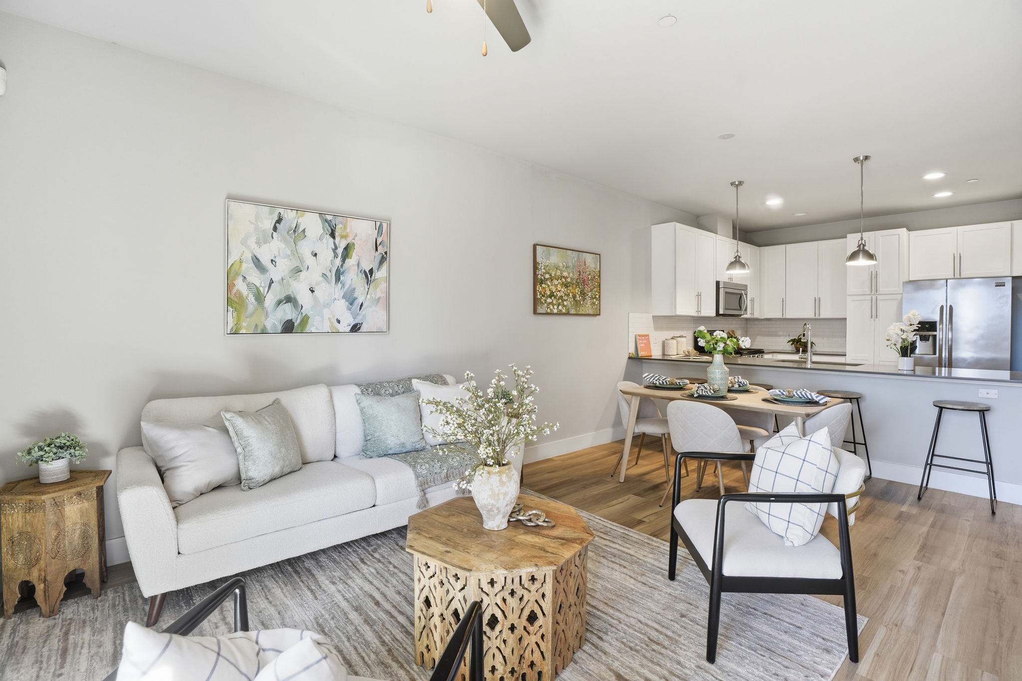 Living area with ceiling fan, light wood finished floors, and recessed lighting