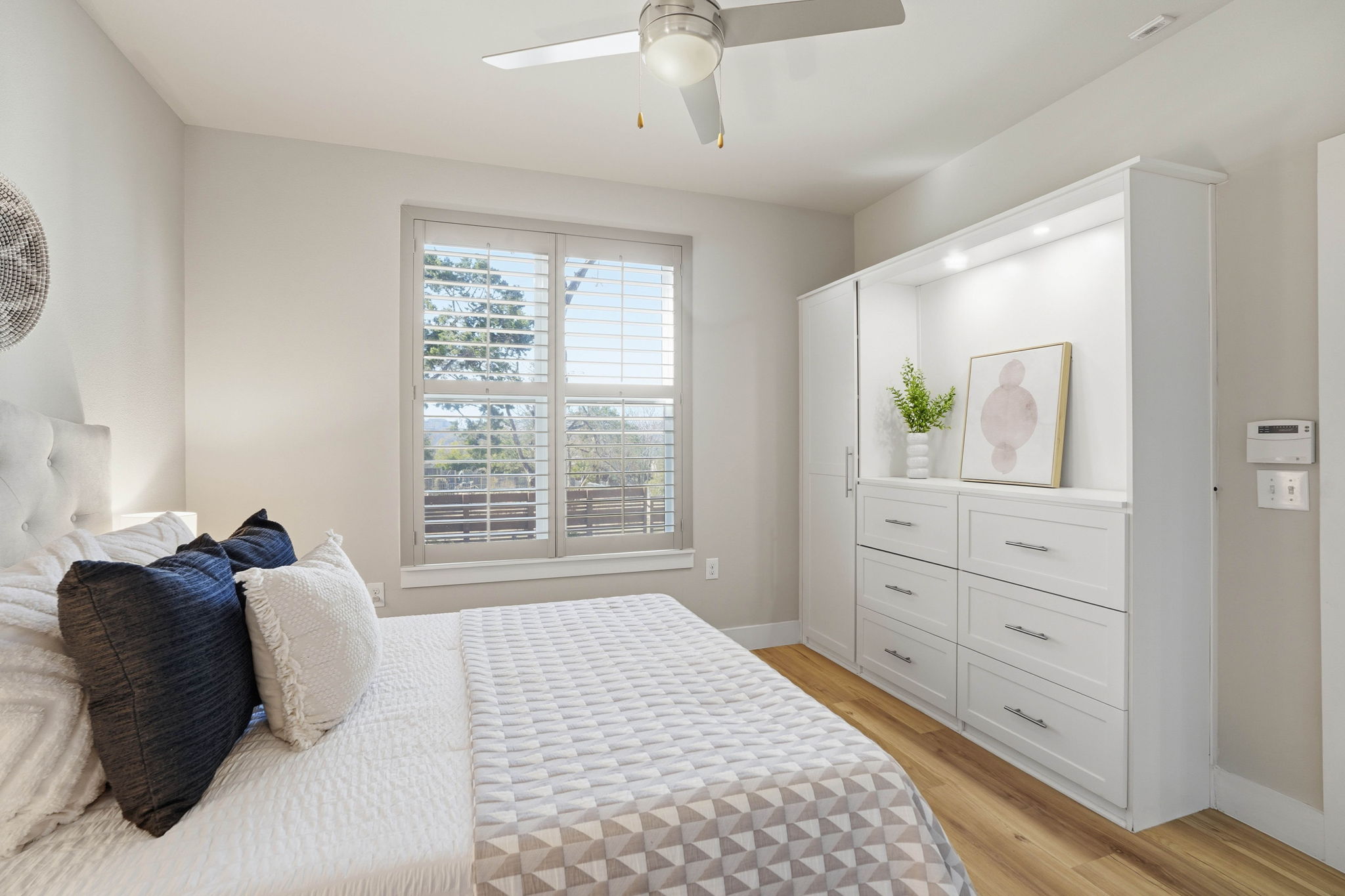 2805 Dulce Lane, Unit 1002 Austin, TX 78704 - Photo 18 of 24 Bedroom with light wood-style floors and a ceiling fan