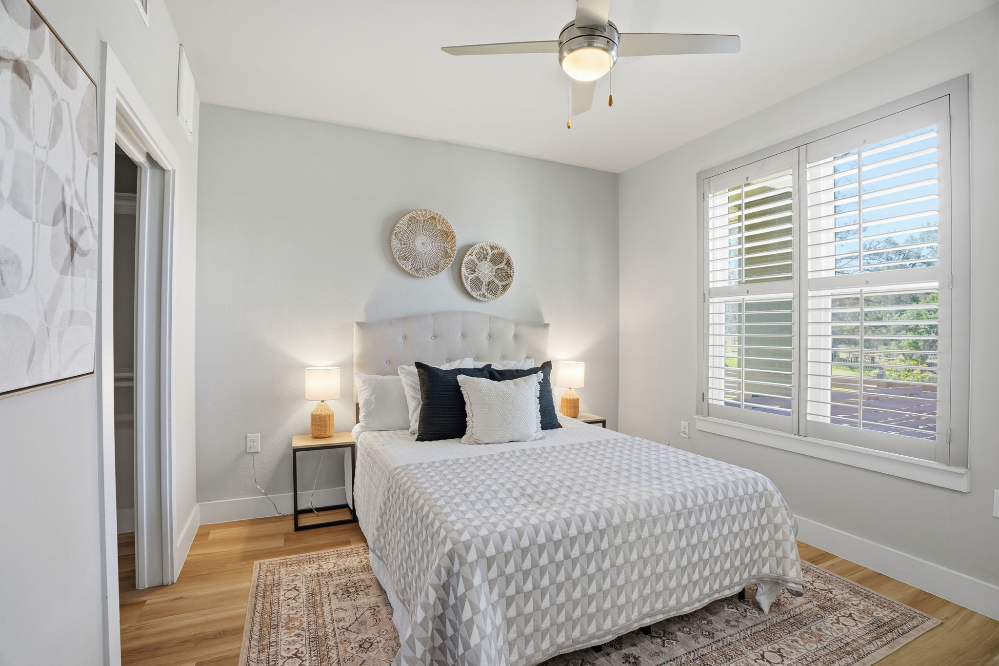 2805 Dulce Lane, Unit 1002 Austin, TX 78704 - Photo 18 of 23 Bedroom with light wood-style floors and ceiling fan