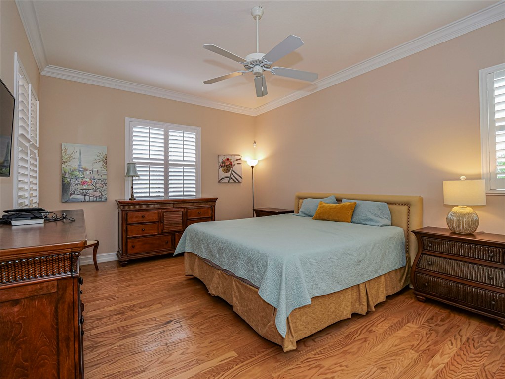 4570 Bridgepointe Way, Unit 148 Vero Beach, FL 32967 - Photo 14 of 32 a bedroom with a bed and dresser with wooden floor