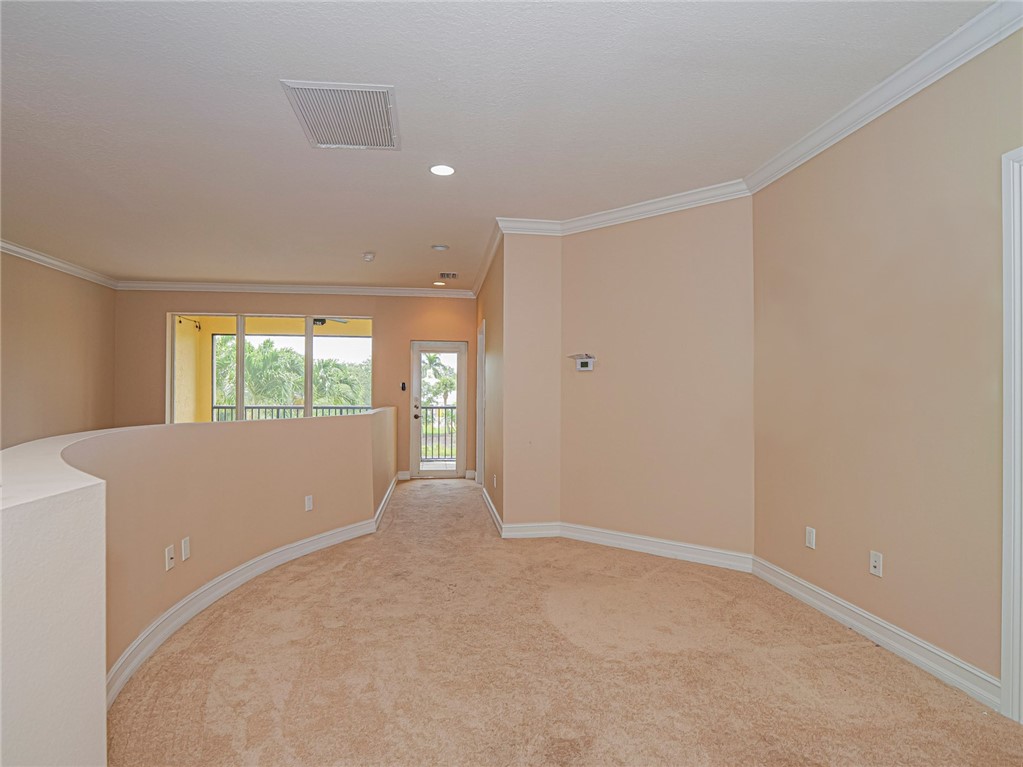 4570 Bridgepointe Way, Unit 148 Vero Beach, FL 32967 - Photo 17 of 32 a view of an empty room with wooden floor and a window
