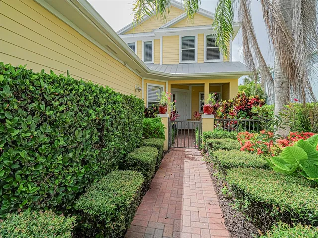 a view of a house with potted plants