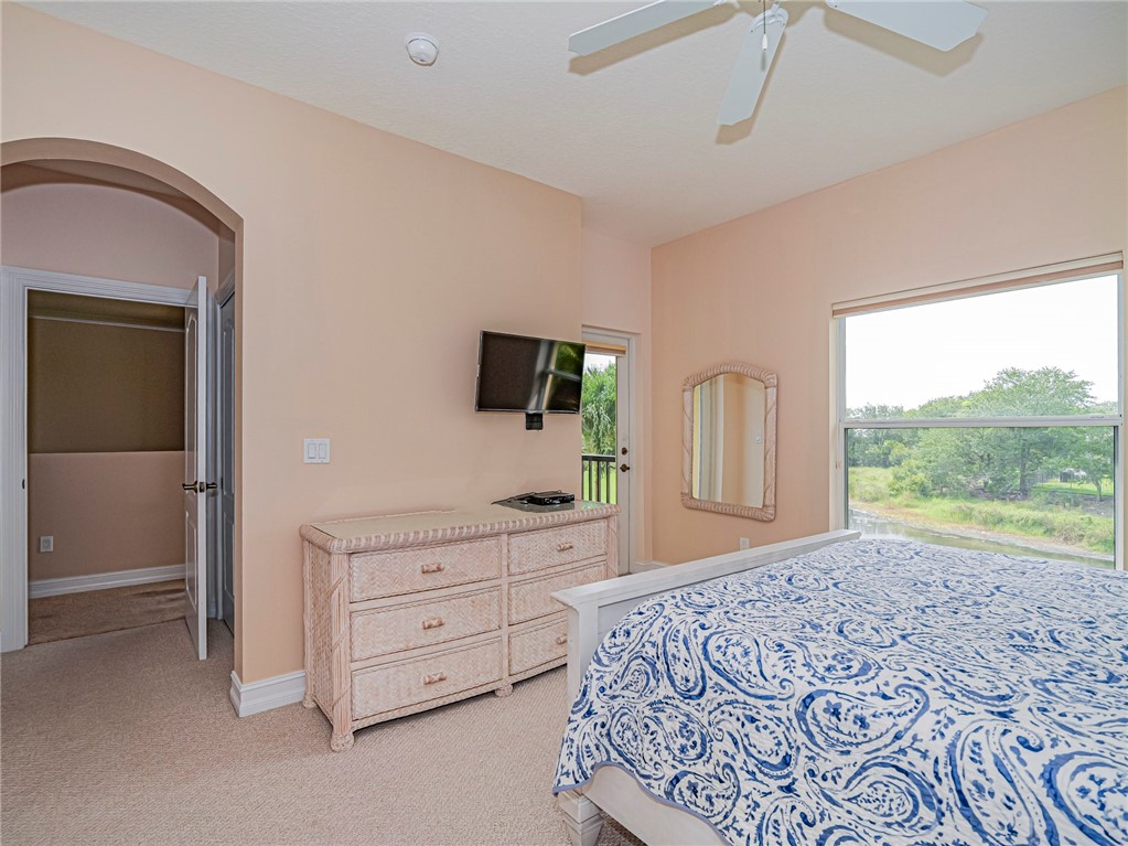 4570 Bridgepointe Way, Unit 148 Vero Beach, FL 32967 - Photo 21 of 32 a bedroom with a bed and a flat screen tv