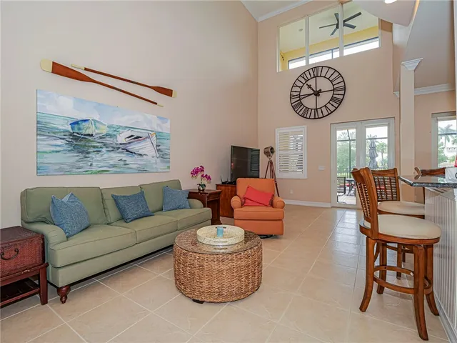 a living room with furniture a clock and a view of bathroom