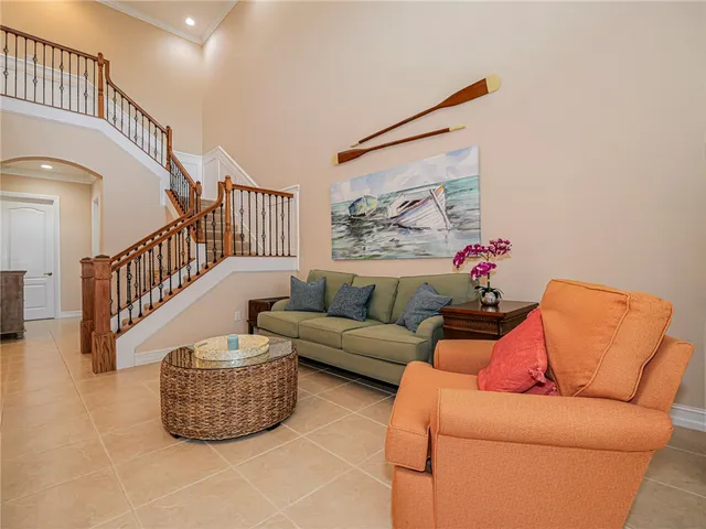 a living room with furniture and stairs