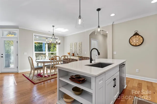 a kitchen with a sink a stove and chairs