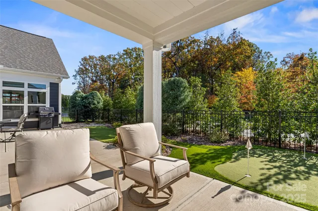 a view of a patio with a table chairs and a backyard