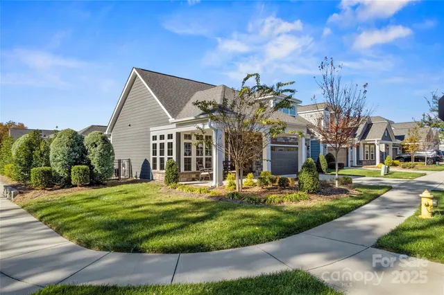 a front view of a house with a yard table and chairs