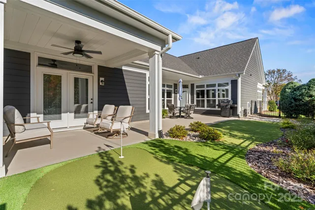 a view of a house with backyard porch and sitting area