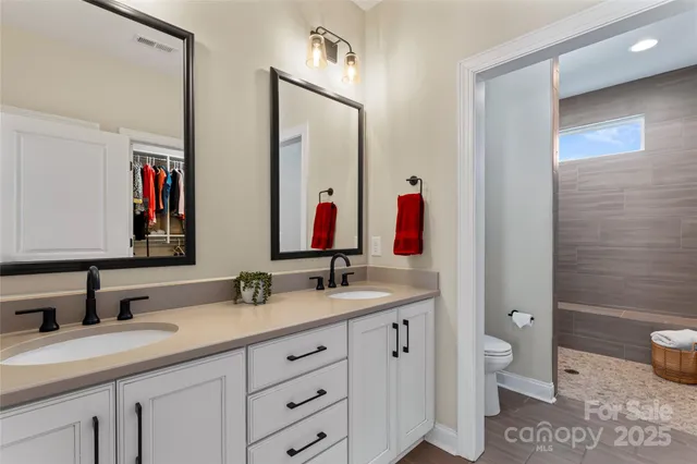 a bathroom with a double vanity sink and a mirror