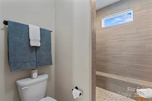 a bathroom with a toilet and a shower