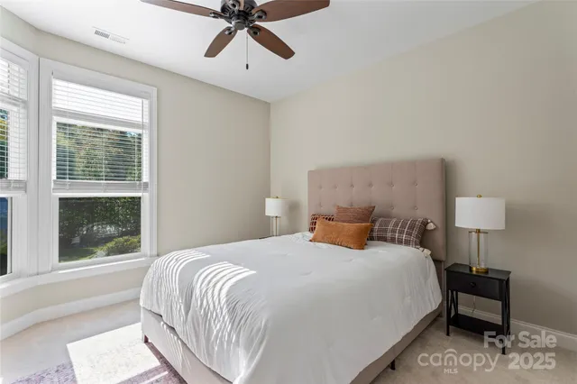 a bedroom with a bed lamp and window