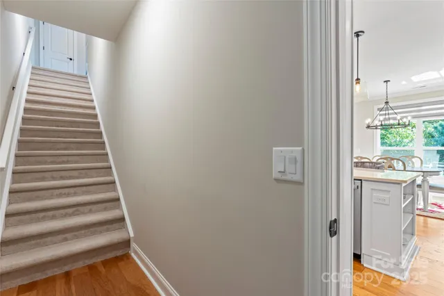 a view of a hallway with wooden floor and entryway