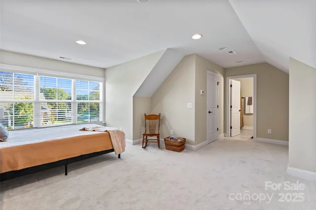 a room with a bed and large window