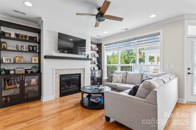 a living room with furniture a flat screen tv and a fireplace