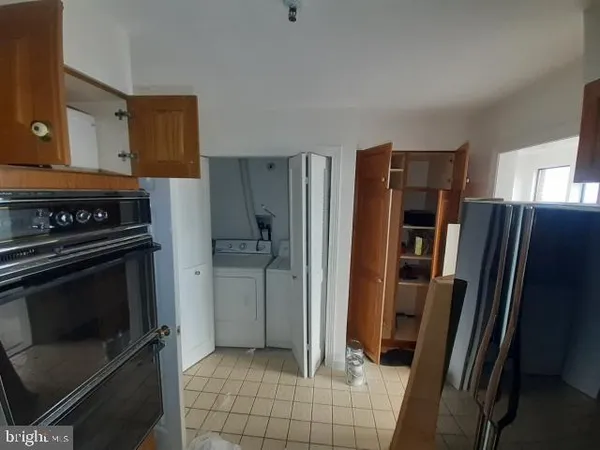 a kitchen with a refrigerator stove and cabinets