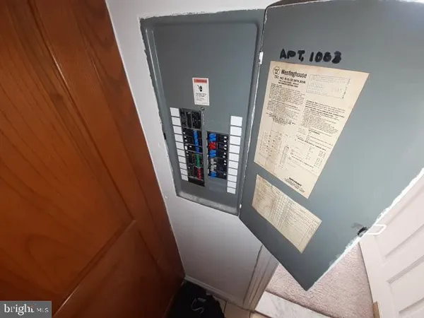 a view of a hallway to a livingroom with furniture
