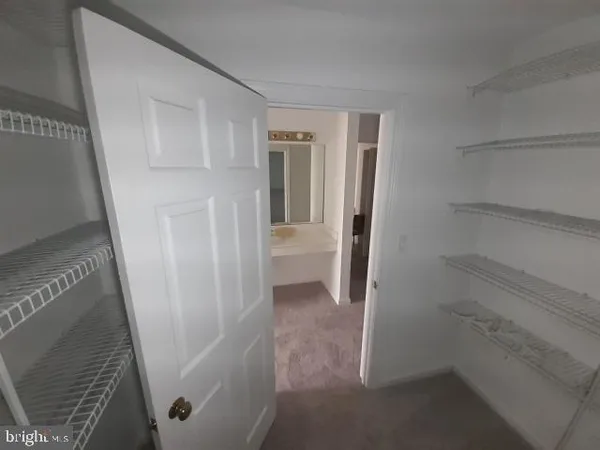 a view of an empty room and closet