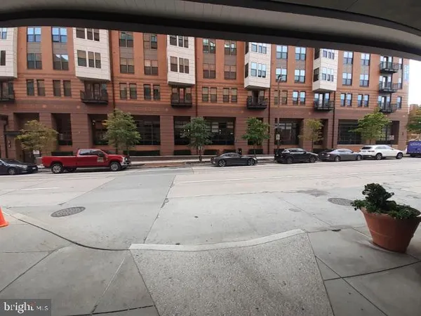 a front view of building with cars parked