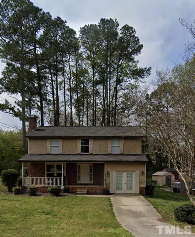 7101 Summerland Drive Raleigh, NC 27612 - Photo 2 of 3 a front view of a house with a garden