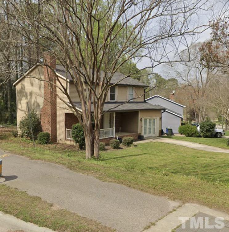 7101 Summerland Drive Raleigh, NC 27612 - Photo 3 of 3 a yellow house with trees in front of it