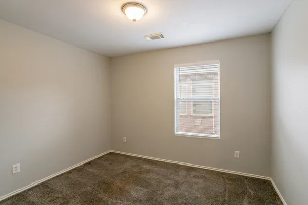 a view of an empty room and a window