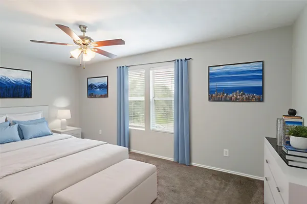a bedroom with a bed and ceiling fan