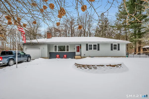 a view of a house with a yard covered in snow