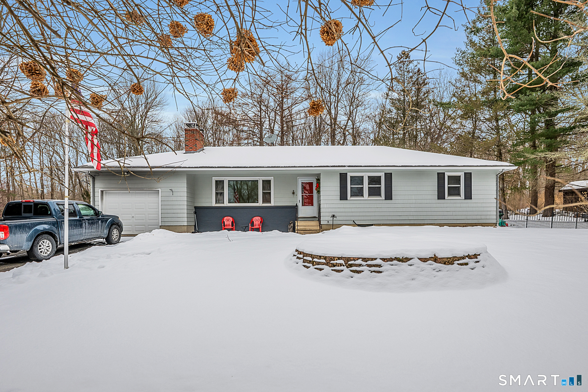 a view of a house with a yard covered in snow