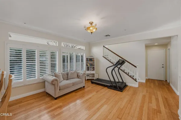 a living room with furniture and a wooden floor