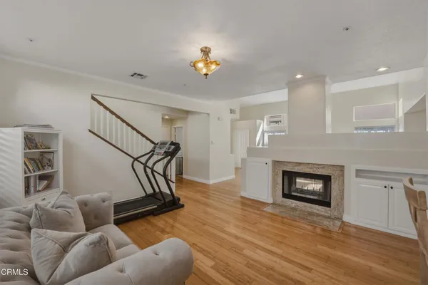 a living room with furniture and a wooden floor