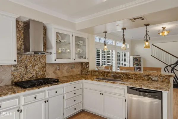 a kitchen with granite countertop a sink and cabinets