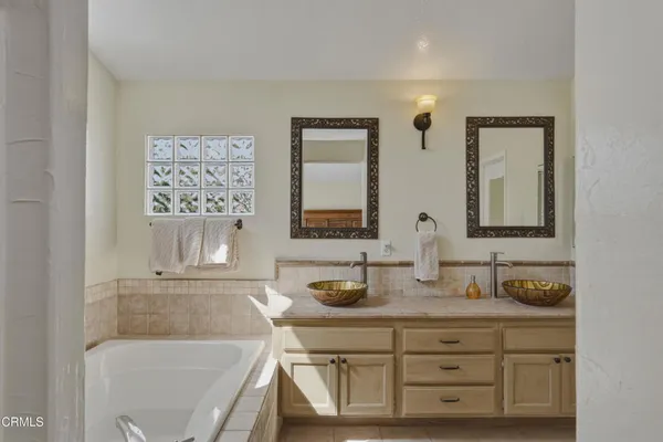 a bathroom with a granite countertop sink mirror and vanity