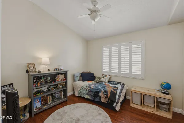 a bedroom with a bed a dresser and a window