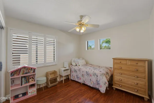 a bedroom with a bed and a bookshelf