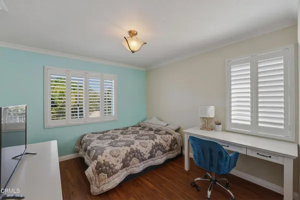 a bedroom with a bed and a desk