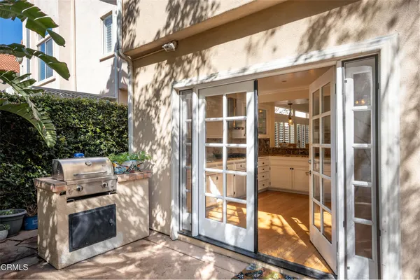 a view of a porch with a floor to ceiling window and wooden fence