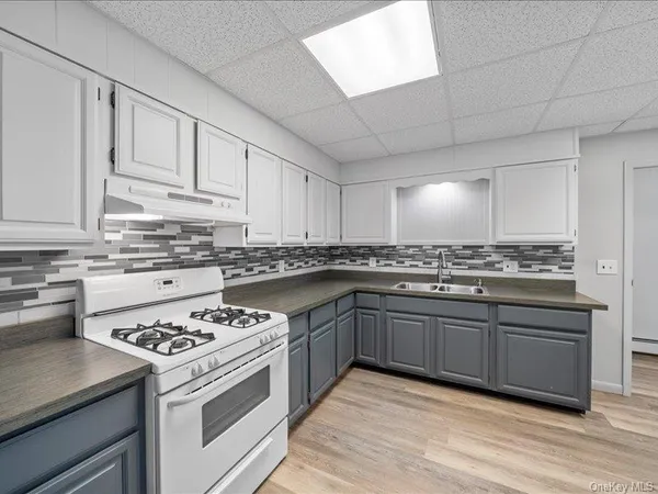 a kitchen with stainless steel appliances granite countertop a stove sink and cabinets