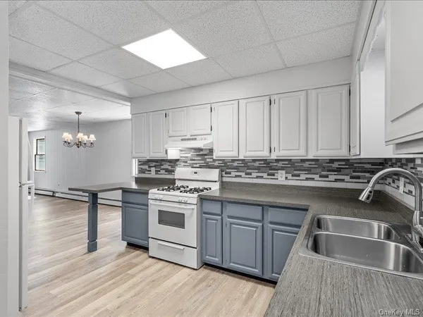 a kitchen with granite countertop a sink and cabinets