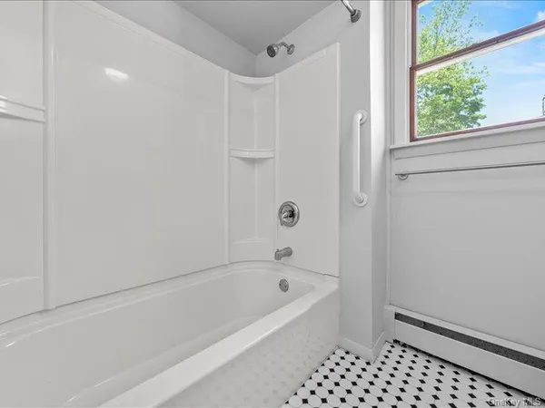 a bathroom with a bathtub and a shower