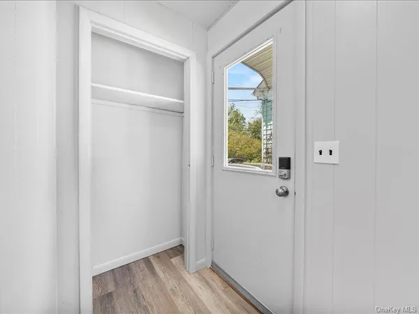 a view of an entryway with wooden floor