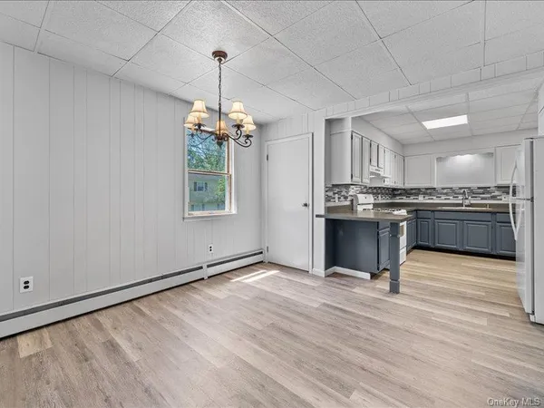 a view of kitchen with granite countertop cabinets and wooden floor