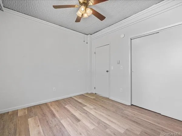 a view of a room with wooden floor