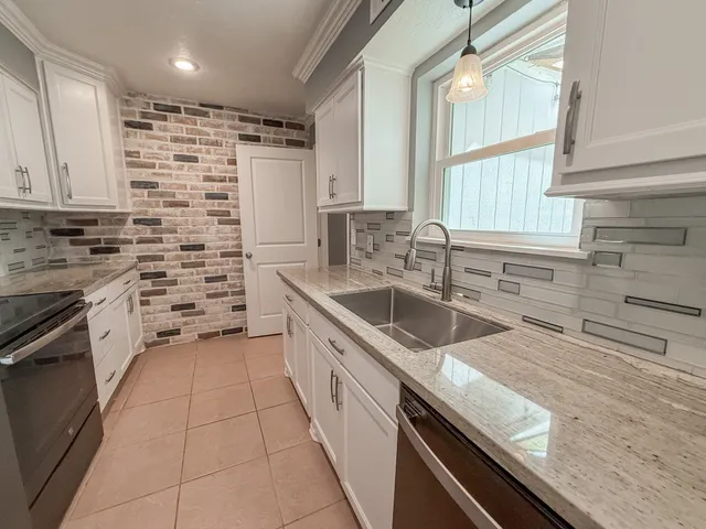 a kitchen with a sink stove and cabinets