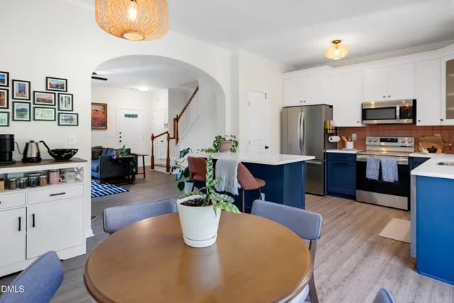 a dining room with furniture and wooden floor