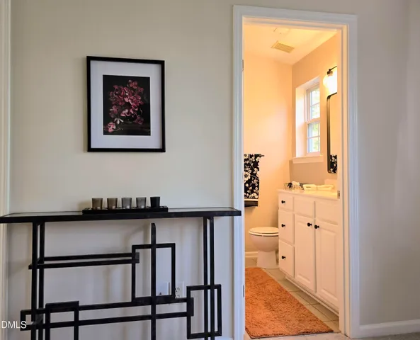 a bedroom with bed and a chandelier
